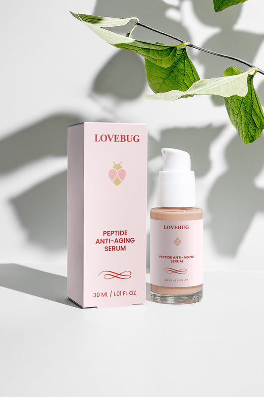 LOVEBUG Peptide Anti-Aging Serum and carton under dappled leaf shadow